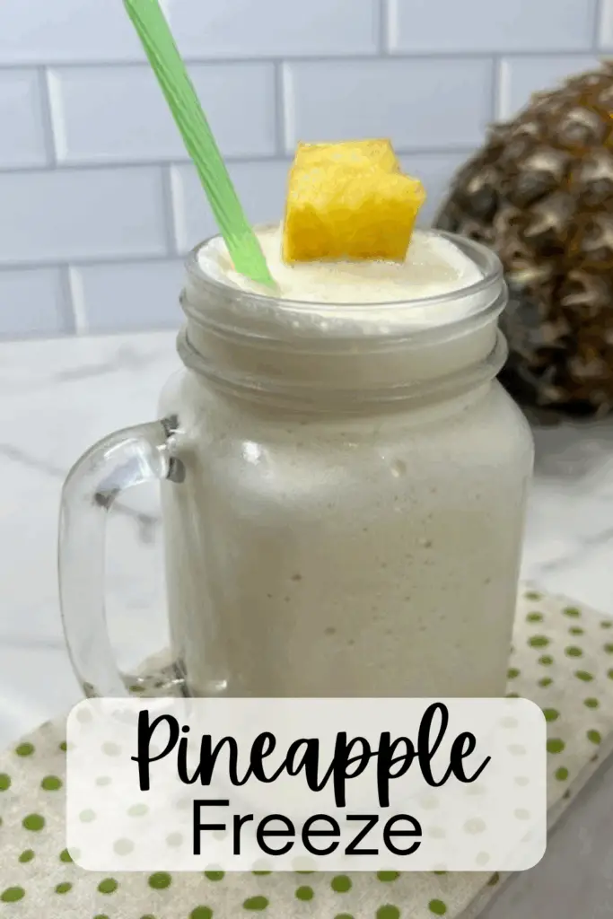 This Pineapple Freeze beverage is a quick and easy frozen treat perfect for hot summer days, family gatherings, or just a fun dessert beverage! It is made with just a few simple ingredients. It's cool, creamy and icy with a tropical flavor in every sip. #PineappleFreeze #SummerSnacks #FrozenFruitDessert #BlenderTreat #EasyPineappleRecipe #HomemadeDoleWhip #TropicalDesserts