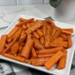 Roasted Carrots on a serving plate garnished with parsley.