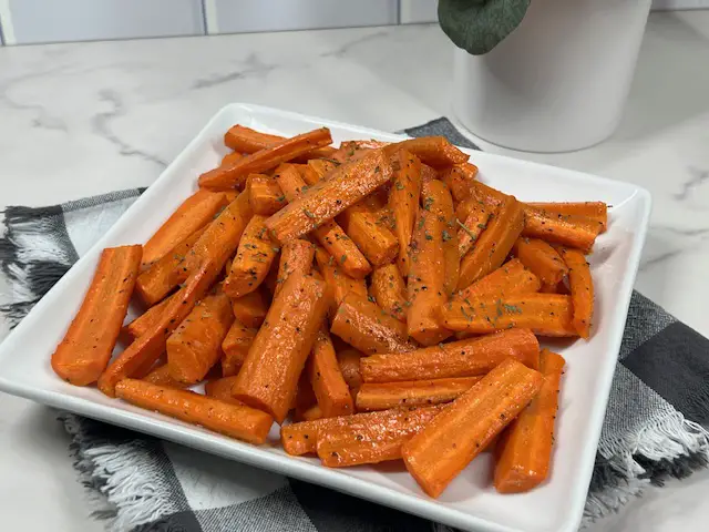 Roasted Carrots on a serving plate garnished with parsley.