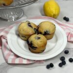 Homemade lemon blueberry muffins served on plate.
