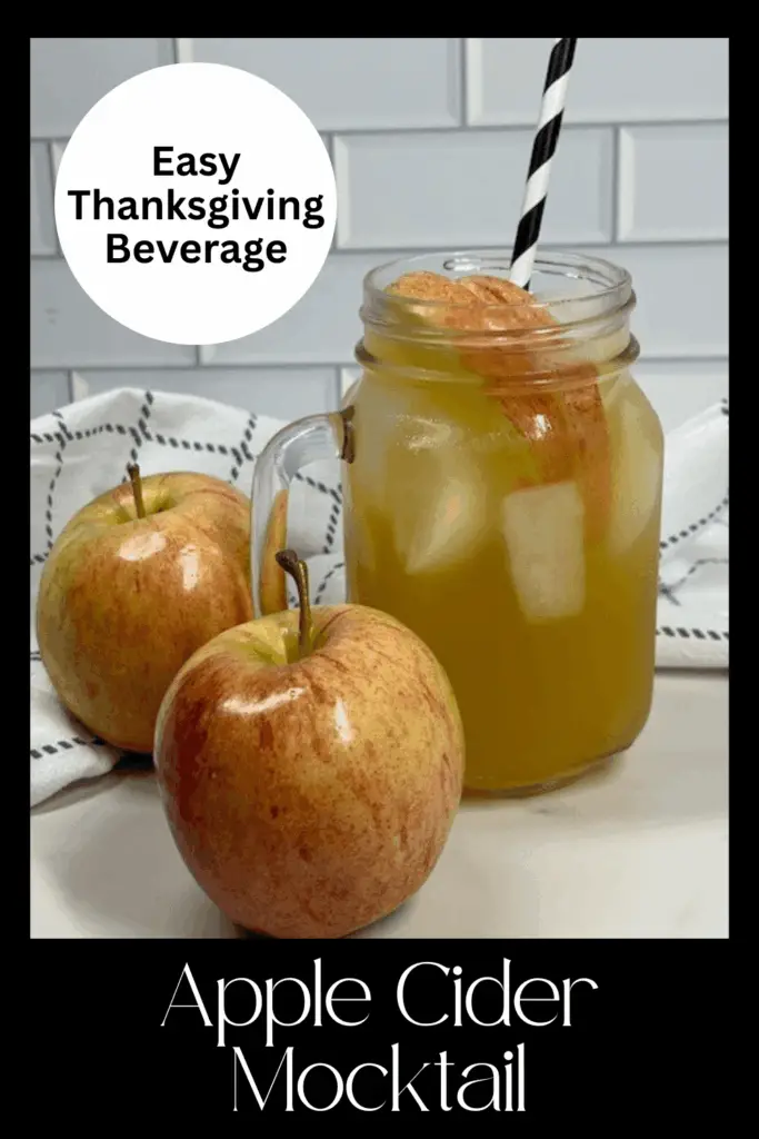 Festive apple cider mocktail served over ice with apple slices.