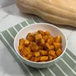Roasted butternut squash pieces ready to serve as a fall side dish.